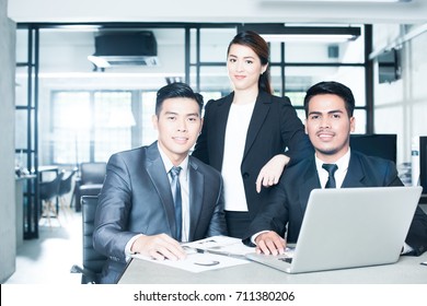 Young And Successful Asian Businesspeople. Image With Lens Flare Effect.