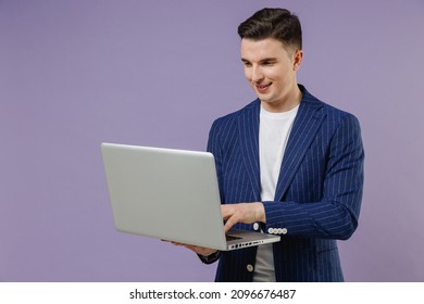 Young successful employee business man corporate lawyer 20s wear formal blue suit white t-shirt work in office hold use work on laptop pc computer isolated on pastel purple background studio portrait.