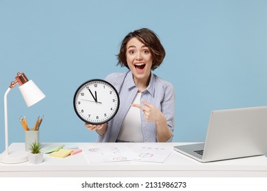 Young Successful Employee Business Woman In Casual Shirt Sit Work At White Office Desk With Pc Laptop Point Index Finger On Clock Isolated On Pastel Blue Background Studio Portrait Deadline Concept