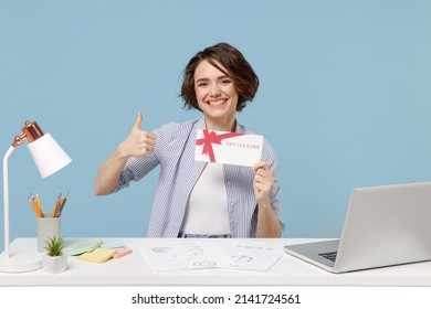 Young Successful Employee Business Woman In Casual Shirt Sit Work At White Office Desk With Pc Laptop Hold Gift Voucher Flyer Mock Up Show Thumb Up Gesture Isolated On Pastel Blue Background Studio