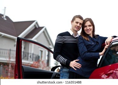 Young Successful Family Near The Car Against His House