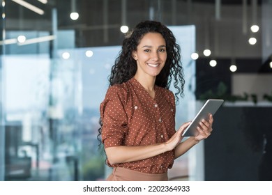 Young and successful female programmer, portrait of female engineer with tablet computer startup worker working inside office building using tablet for testing applications smiling looking at camera - Shutterstock ID 2202364933