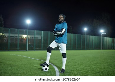 Young Successful Football Player Or Trainer Standing On Large Field At Stadium During Training At Night