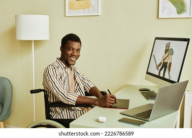 Young successful graphic designer in wheelchair drawing warrior while holding stylus over tablet and looking at camera in home office - Powered by Shutterstock