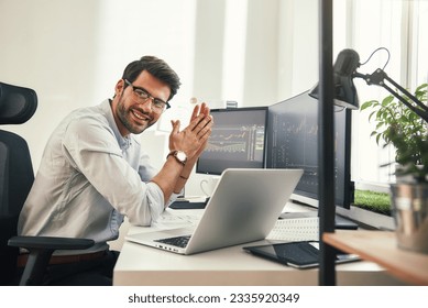 Young and successful. Happy bearded trader in formal wear and eyeglasses looking at camera and smiling while sitting in his modern office. - Shutterstock ID 2335920349