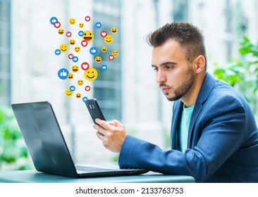 Young successful influencer or blogger watches a social network news feed, gets likes and views in the form of animated emoji. The concept of social medias, internet and online communications.