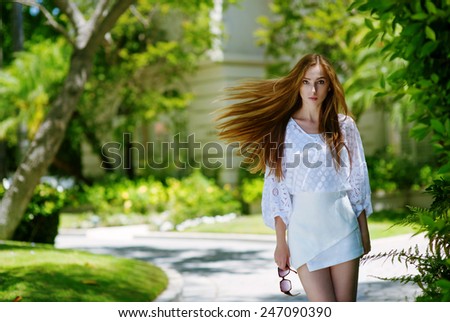Young successful lady leaving expensive country house