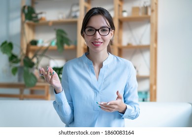 Young successful woman psychotherapist with glasses conducting consultation. Smiling and gesturing with his hands. - Shutterstock ID 1860083164