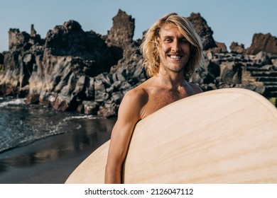 Young Surfer Happy Man Holding Vintage Wood Surf Board On The Beach - Focus On Face