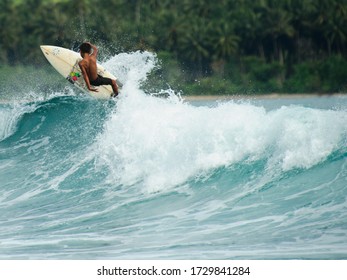 Young Surfer Practicing At Sorake Beach Nias