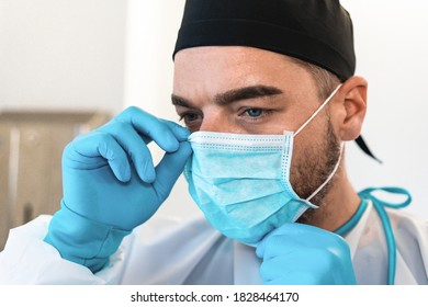 Young surgeon doctor wearing medical mask - Focus on man's eye