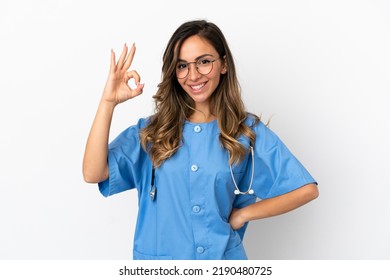 Young surgeon doctor woman over isolated white wall showing ok sign with fingers - Shutterstock ID 2190480725