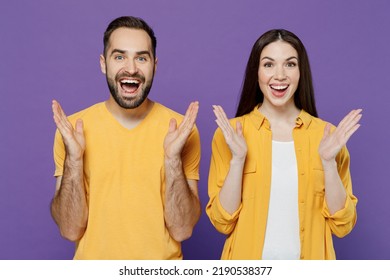 Young Surprised Excited Shocked Amazed Fun Couple Two Friends Family Cool Man Woman 20s Together In Yellow Casual Clothes Look Camera Spread Hands Isolated On Plain Violet Background Studio Portrait