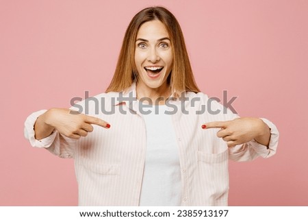 Young surprised excited shocked happy woman she wear shirt white t-shirt casual clothes point index fingers on herself isolated on plain pastel light pink background studio portrait. Lifestyle concept