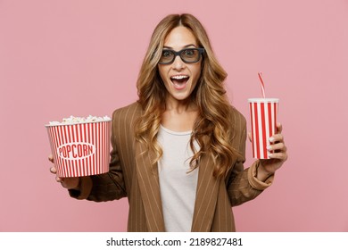 Young surprised shocked exultant jubilant amazed woman in 3d glasses watch movie film hold bucket of popcorn cup of soda pop in cinema isolated on plain pastel light pink background studio portrait - Powered by Shutterstock