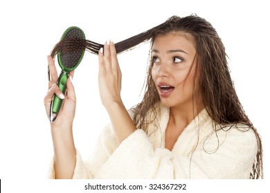 Young Surprised Woman In Bathrobe Brush Her Moist Hair