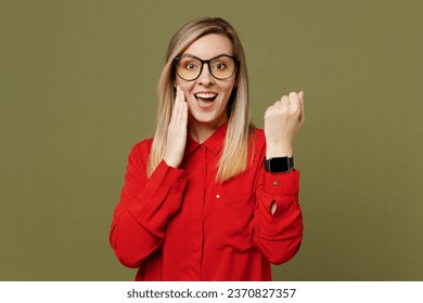 Young surprised woman wears red shirt casual clothes glasses wear show point index finger on smartwatch with blank screen isolated on plain pastel green background studio portrait. Lifestyle concept - Powered by Shutterstock