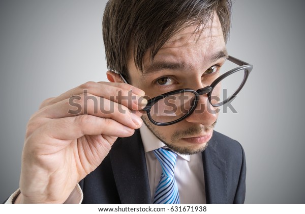 Young Suspicious Businessman Looking You Through Stock Photo (Edit Now ...