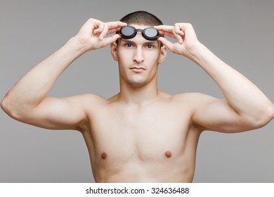 Young swimmer adjusts his goggles - Powered by Shutterstock