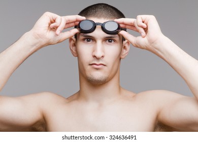 Young swimmer adjusts his goggles - Powered by Shutterstock