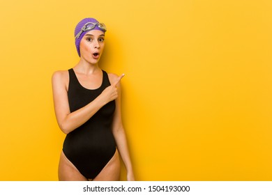 Young Swimmer Caucasian Woman Pointing To The Side