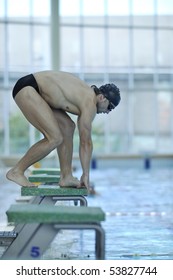 Young Swimmer On Swim Start At Swimming Pool Ready For Jump Race And Win