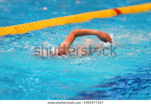 Young swimmer\
trains in the pool with clean\
water