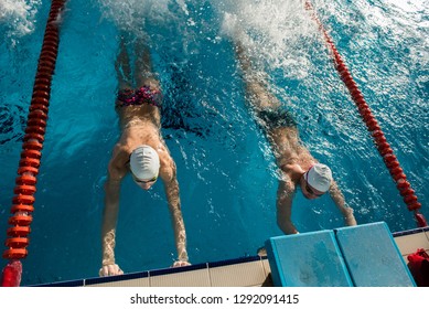 Young Swimmers Training A Flutter Kick In A Swimming Pool