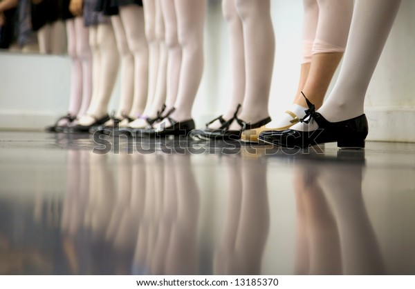Young\
tap dancer... low angle shot of just feet and\
legs