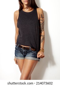 Young tattooed woman wearing grey sleeveless t-shirt