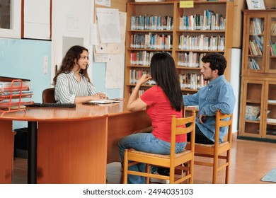 Young teacher confronts parents, scolding them, frustrated teacher, parents meeting with their children's teacher, teacher talks to parents about how the course is going - Powered by Shutterstock