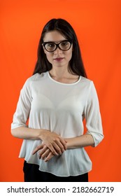  Young Teacher A Girl In A University In Modest Clothes Stands For A Portrait Isolated On A Uniform Background. The Concept Of A Teacher. Knowledge Is Power. Forward Into The Future