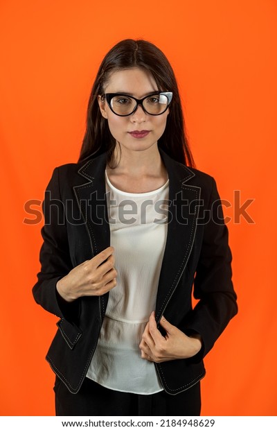
young teacher a girl in a university in modest clothes stands for a
portrait isolated on a uniform background. The concept of a
teacher. Knowledge is power. forward into the
future