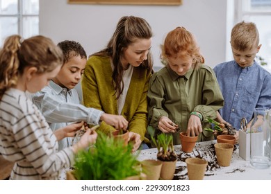 Young teacher learning pupils how to take care about plants. - Powered by Shutterstock