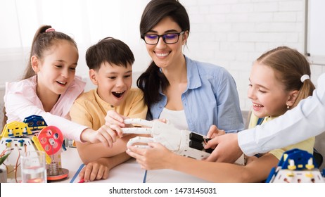 Young Teacher Presenting Robotic Hand To Children At Stem Lesson, Panorama