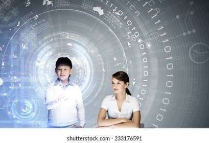 Young teacher and school boy at computing lesson