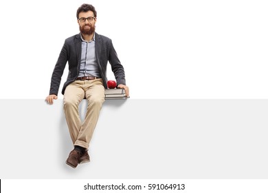 Young Teacher Sitting On A Panel And Looking At The Camera Isolated On White Background