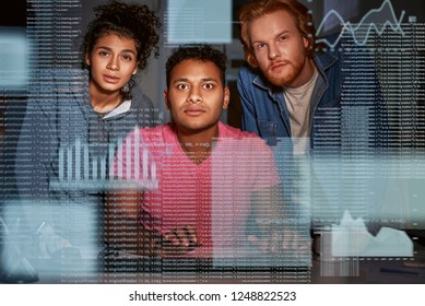 Young team of data analysts are captivated by the code