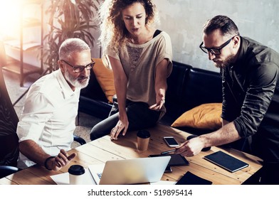 Young Team Of Successful Businessman Found A Great Creative Solution In Modern Coworking Studio.Bearded Man Talking With Colleagues About Startup Project.Business People Brainstorm Concept.Horizontal