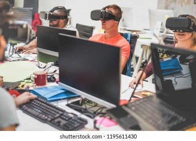 Young teamwork using virtual reality glasses in creative office - Co-workers trying new technology devices at work - Business, marketing and tech trends concept - Focus on right man headset - Powered by Shutterstock - Get 15% off with code: PIKWIZARD15