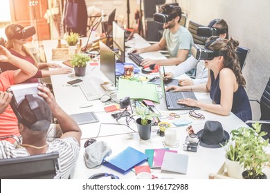 Young teamwork using virtual reality glasses in creative office - Co-workers trying new technology devices at work - Business, marketing and tech trends concept - Focus on bottom woman headset - Powered by Shutterstock - Get 15% off with code: PIKWIZARD15