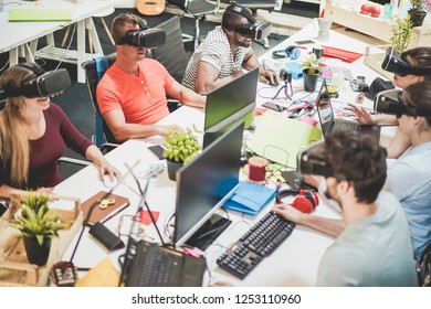 Young teamwork using virtual reality glasses in creative office - Co-workers trying new technology devices at work - Business, marketing and tech trends concept - Focus on left black man headset