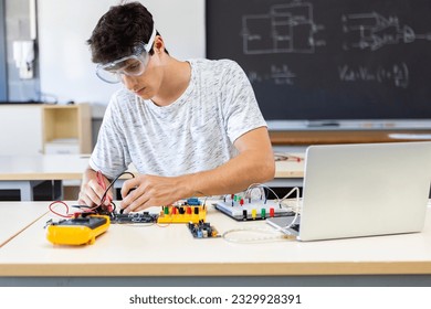 Young tech male student learning electronic circuit system at high school. Education lifestyle concept. - Powered by Shutterstock