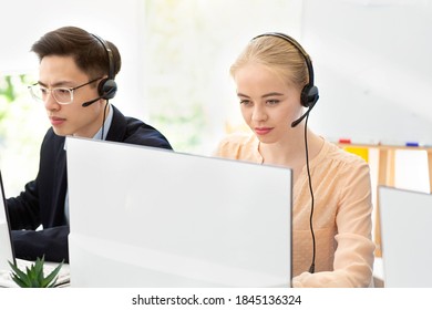 Young tech support operators at work in contemporary call centre. Millennial hotline agents using computers at office, consulting clients, selling goods on phone. Telecommunications concept