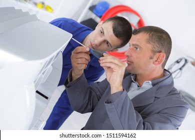 Young Technician Fixing Photo Copier