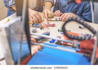 Young technicians making bright models