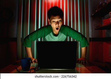 Young Teen Acting Surprised In Front Of A Laptop Computer Photo Of A Young Teen Acting Surprised In Front Of A Laptop Computer