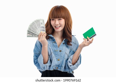 Young Teen Asian Woman Holding American Banknotes That Spread Out In Hand And Holding Bank Account Deposit Passbook, Studio Shot On White Background With Copy Space.