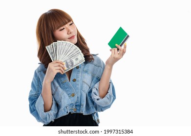 Young Teen Asian Woman Holding American Banknotes That Spread Out In Hand And Holding Bank Account Deposit Passbook, Studio Shot On White Background With Copy Space.