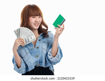 Young Teen Asian Woman Holding American Banknotes That Spread Out In Hand And Holding Bank Account Deposit Passbook, Studio Shot On White Background With Copy Space.